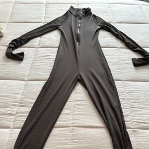 Brown bodysuit with rouche detail in the arms and legs